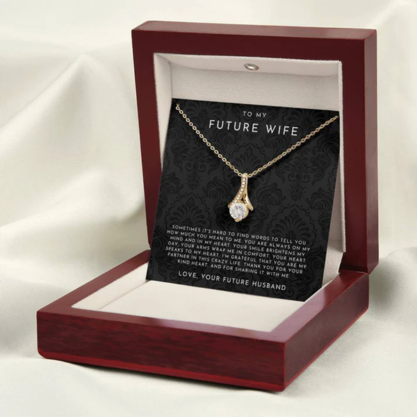 Gold necklace with a heart-shaped pendant on a decorative card for 'Future Wife' with romantic message.